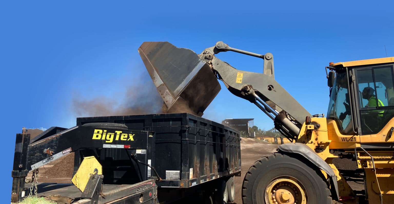 Lindale machine loading dirt into trailer